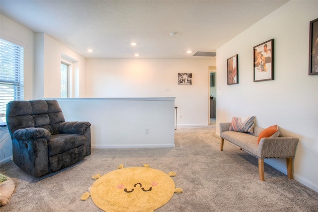 living area with light colored carpet