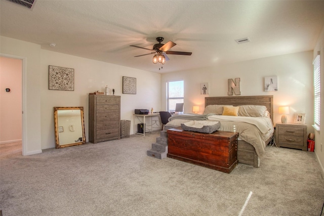 bedroom featuring ceiling fan and light carpet