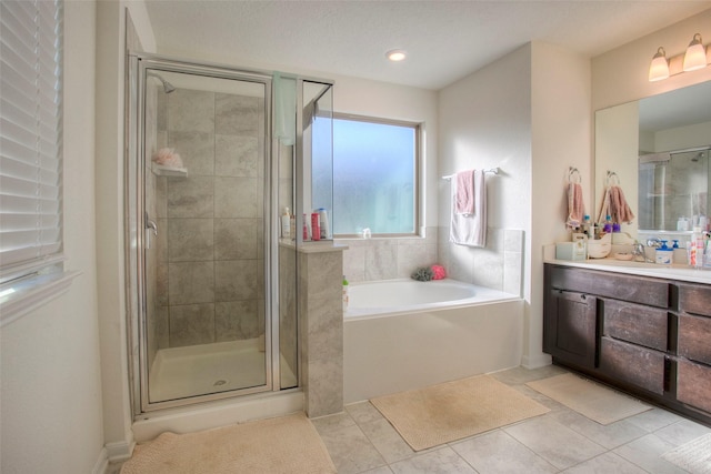 bathroom featuring tile patterned flooring, plus walk in shower, and vanity