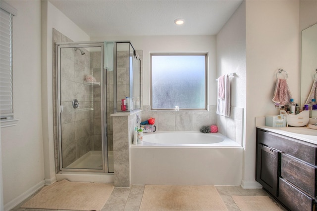 bathroom with vanity, tile patterned floors, and plus walk in shower