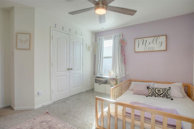 carpeted bedroom featuring a closet and ceiling fan