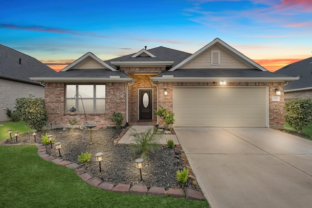 view of front of house featuring a garage and a lawn