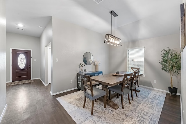 dining area featuring dark wood-type flooring