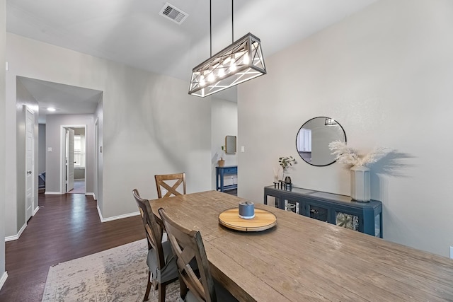 dining space featuring dark wood-type flooring