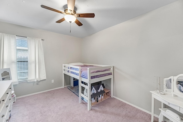 bedroom with ceiling fan and light carpet