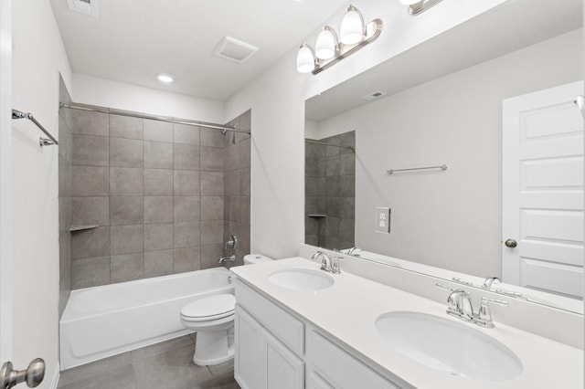 full bathroom with vanity, tile patterned flooring, tiled shower / bath combo, and toilet