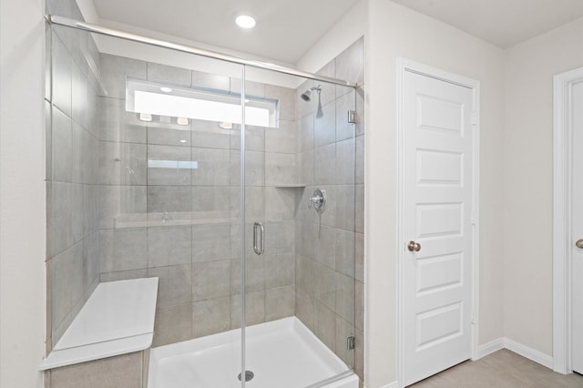 bathroom featuring a shower with door and tile patterned flooring