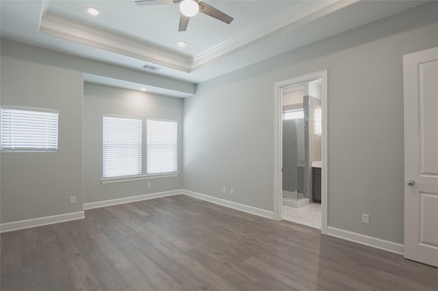 unfurnished room featuring ceiling fan, a raised ceiling, and dark hardwood / wood-style floors