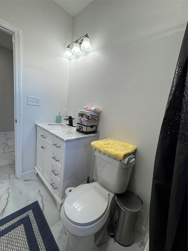 bathroom featuring toilet and vanity