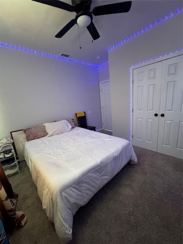 bedroom with ceiling fan, a closet, and carpet flooring