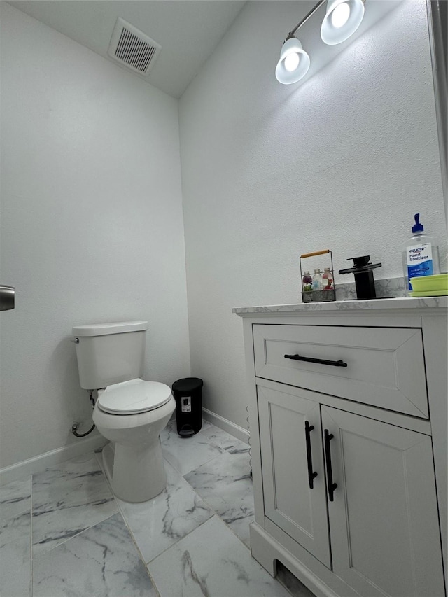 bathroom featuring toilet and vanity