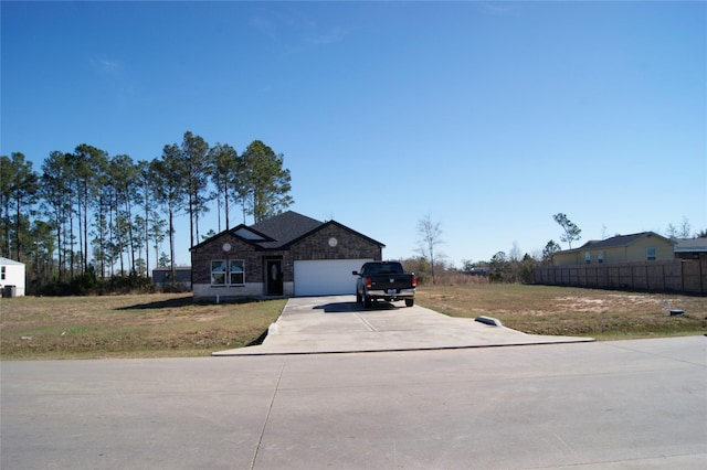 view of front of house featuring a garage and a front lawn