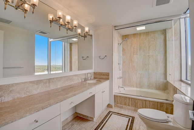 full bathroom featuring toilet, tiled shower / bath combo, ornamental molding, and vanity