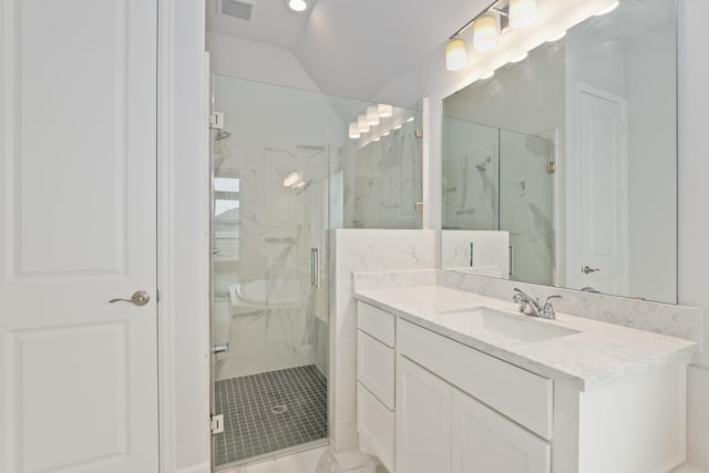 bathroom with an enclosed shower, vaulted ceiling, and vanity