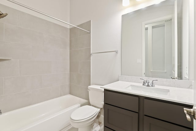 full bathroom featuring toilet, tiled shower / bath combo, and vanity