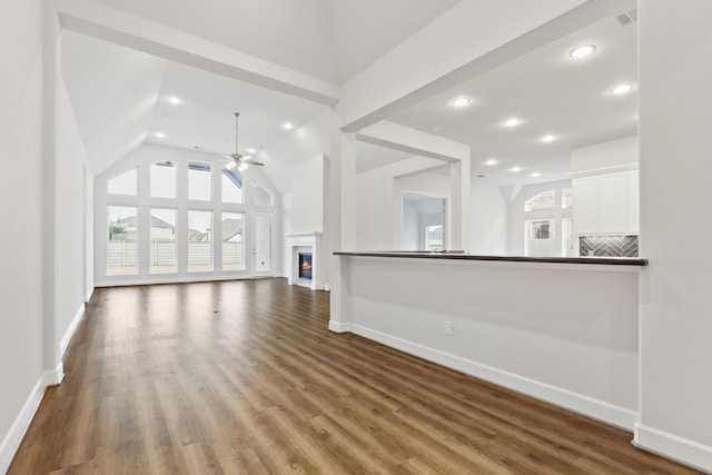 unfurnished living room featuring hardwood / wood-style flooring, high vaulted ceiling, and ceiling fan