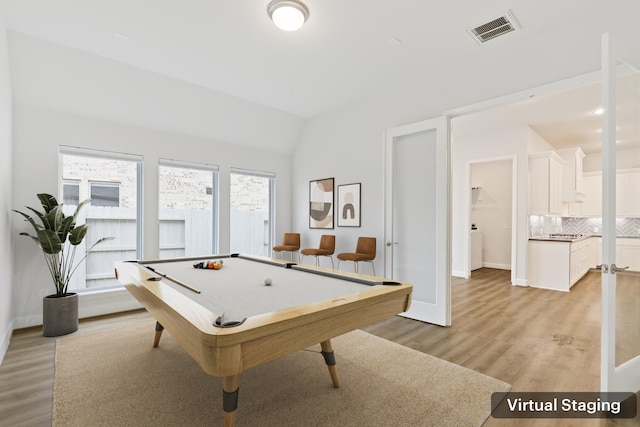 game room featuring lofted ceiling, billiards, and light hardwood / wood-style flooring