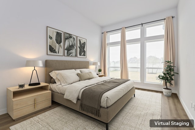 bedroom with a mountain view and wood-type flooring