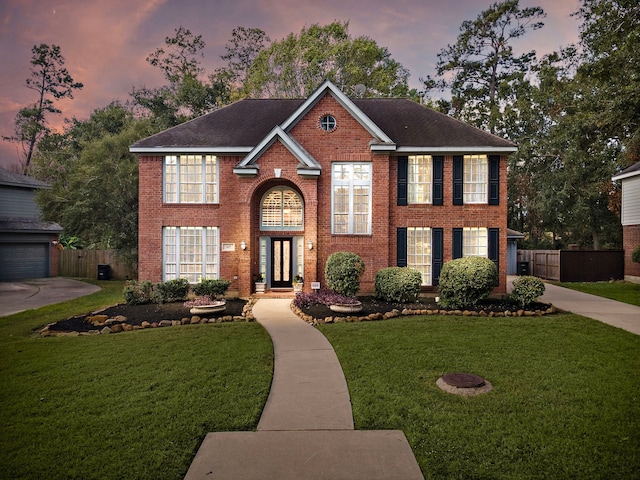 view of front of property with a yard and a garage