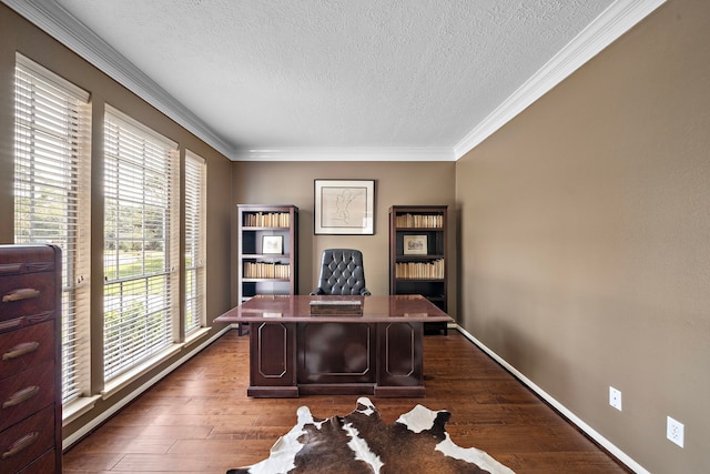 office featuring a textured ceiling, dark wood-type flooring, and a wealth of natural light