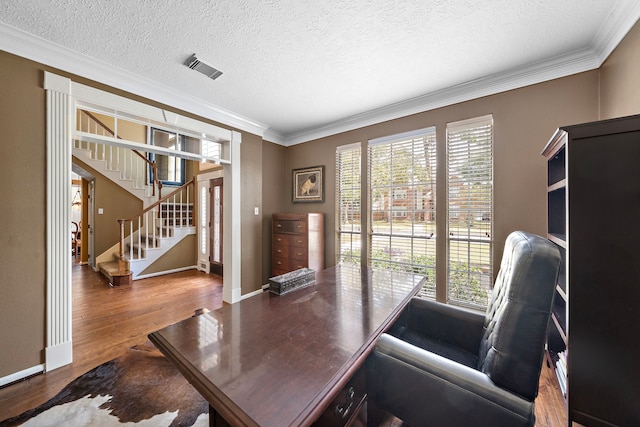 office with a textured ceiling, ornamental molding, and hardwood / wood-style flooring