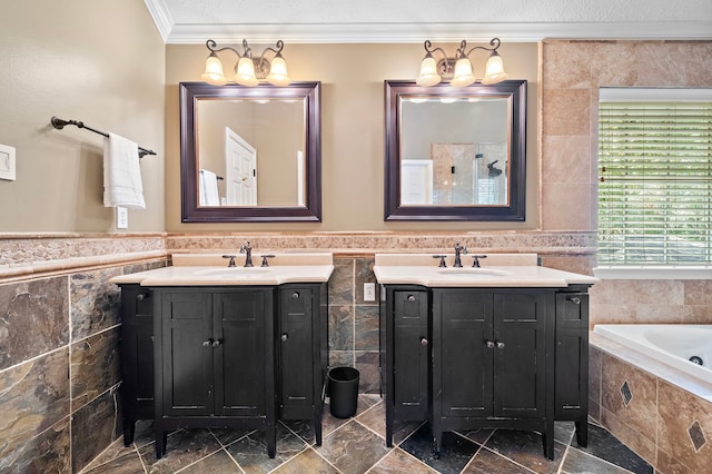 bathroom with tile walls, a washtub, ornamental molding, and vanity