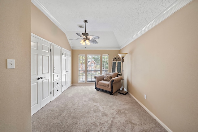 sitting room with vaulted ceiling, light colored carpet, ceiling fan, and crown molding