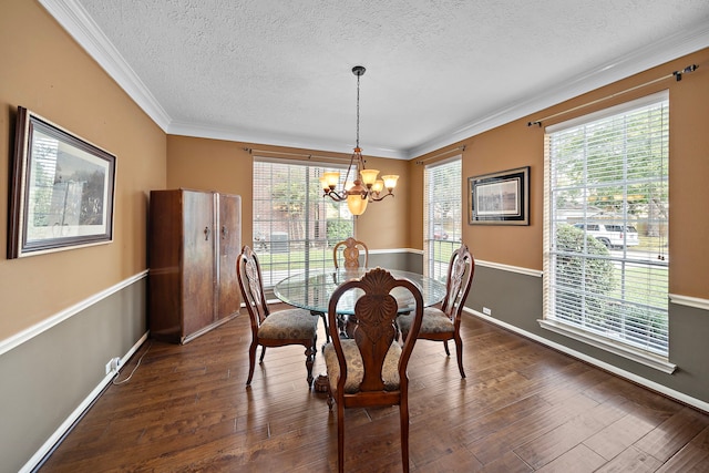 dining room with a healthy amount of sunlight, dark hardwood / wood-style flooring, an inviting chandelier, and crown molding