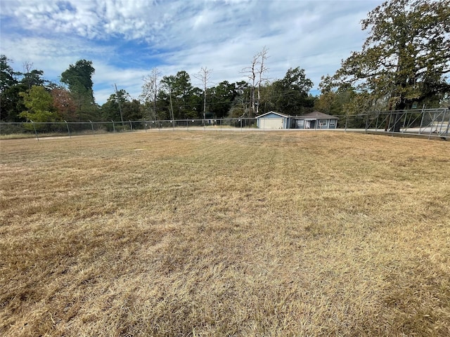 view of yard with a garage and fence