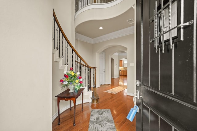 foyer featuring hardwood / wood-style flooring and ornamental molding