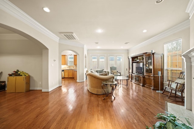 living room with hardwood / wood-style flooring and crown molding