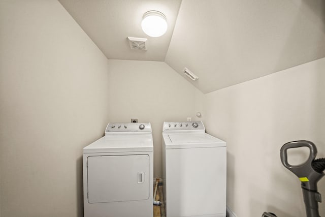 clothes washing area featuring washer and dryer