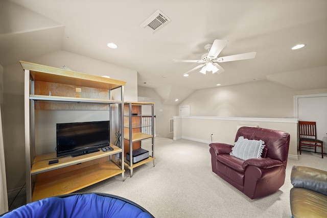 carpeted living room with ceiling fan and vaulted ceiling