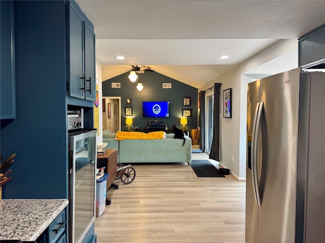 kitchen with ceiling fan, vaulted ceiling, wine cooler, light wood-style floors, and stainless steel fridge