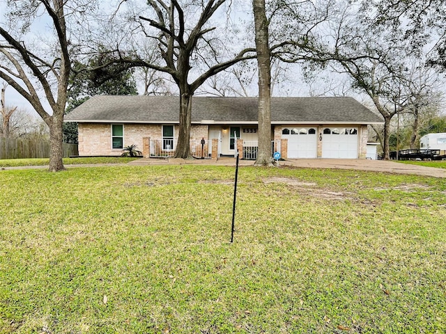 single story home featuring brick siding, a garage, driveway, and a front yard