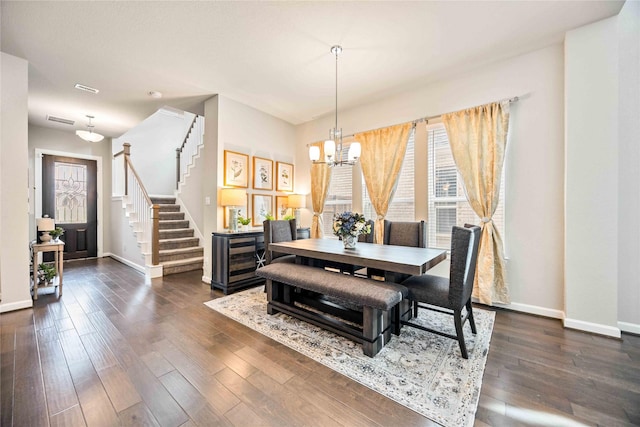 dining room with an inviting chandelier and dark hardwood / wood-style flooring