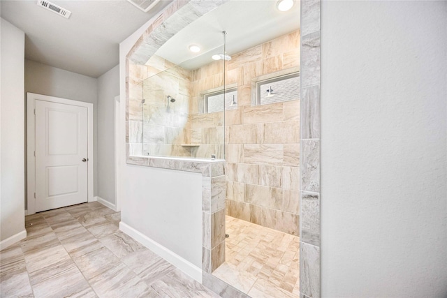 bathroom with a tile shower