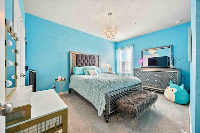 carpeted bedroom featuring a notable chandelier