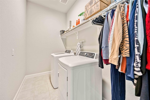 washroom featuring washer and dryer and light tile patterned floors