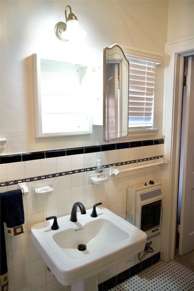 bathroom featuring tile walls, sink, and heating unit