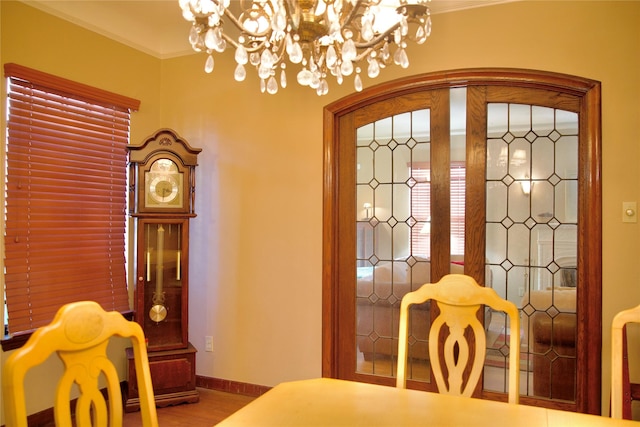 interior space featuring ornamental molding, an inviting chandelier, and hardwood / wood-style flooring