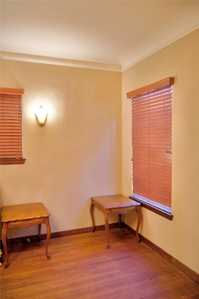 sitting room featuring hardwood / wood-style flooring and crown molding