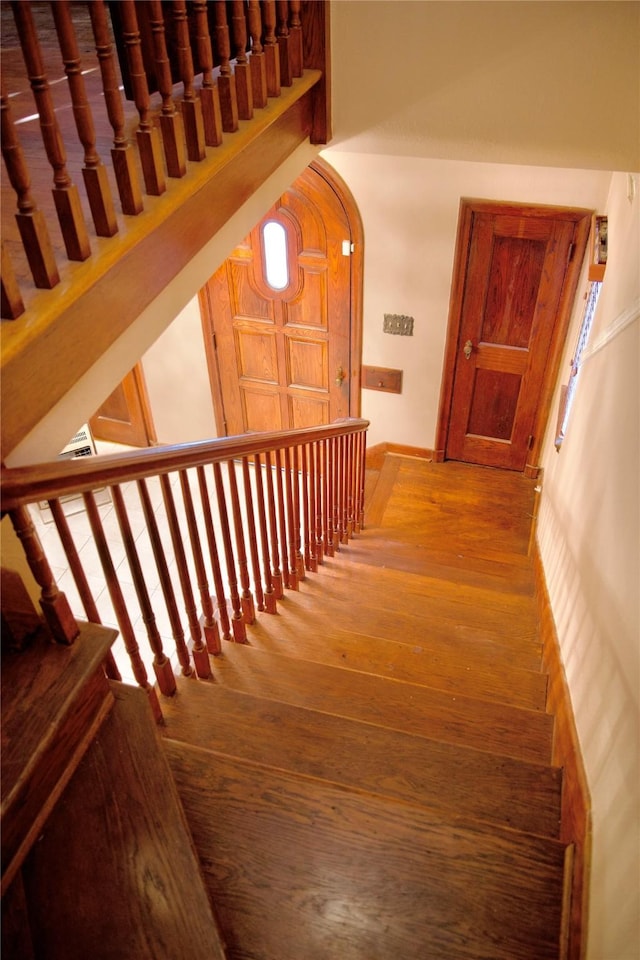 staircase with hardwood / wood-style floors