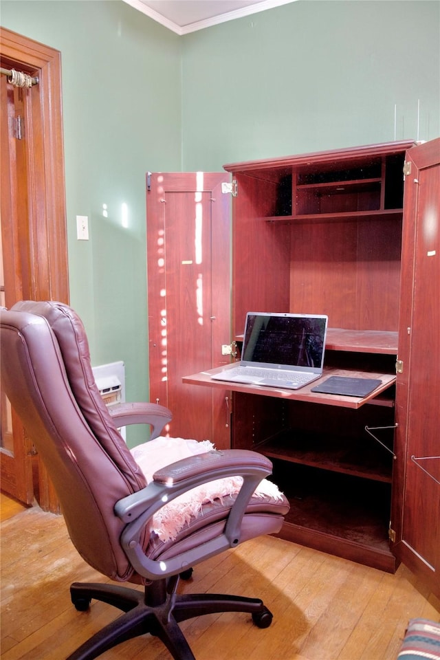 office area with crown molding and light hardwood / wood-style flooring