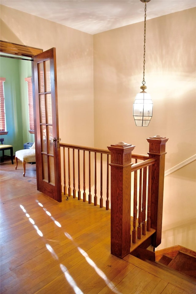 stairway with hardwood / wood-style floors