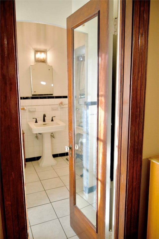 bathroom with tile walls and tile patterned flooring