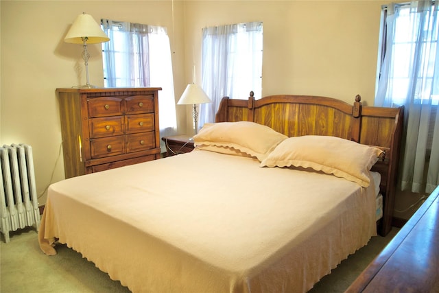 carpeted bedroom featuring radiator heating unit