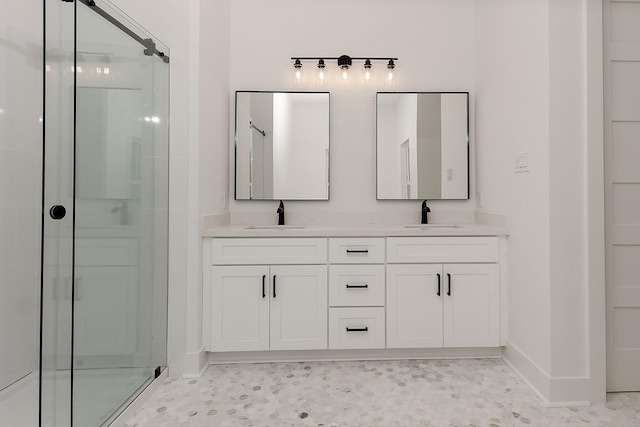 bathroom with a shower with door and vanity