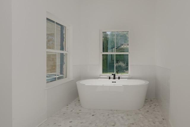 bathroom with a tub to relax in