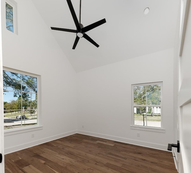 spare room featuring ceiling fan, dark wood-type flooring, and high vaulted ceiling